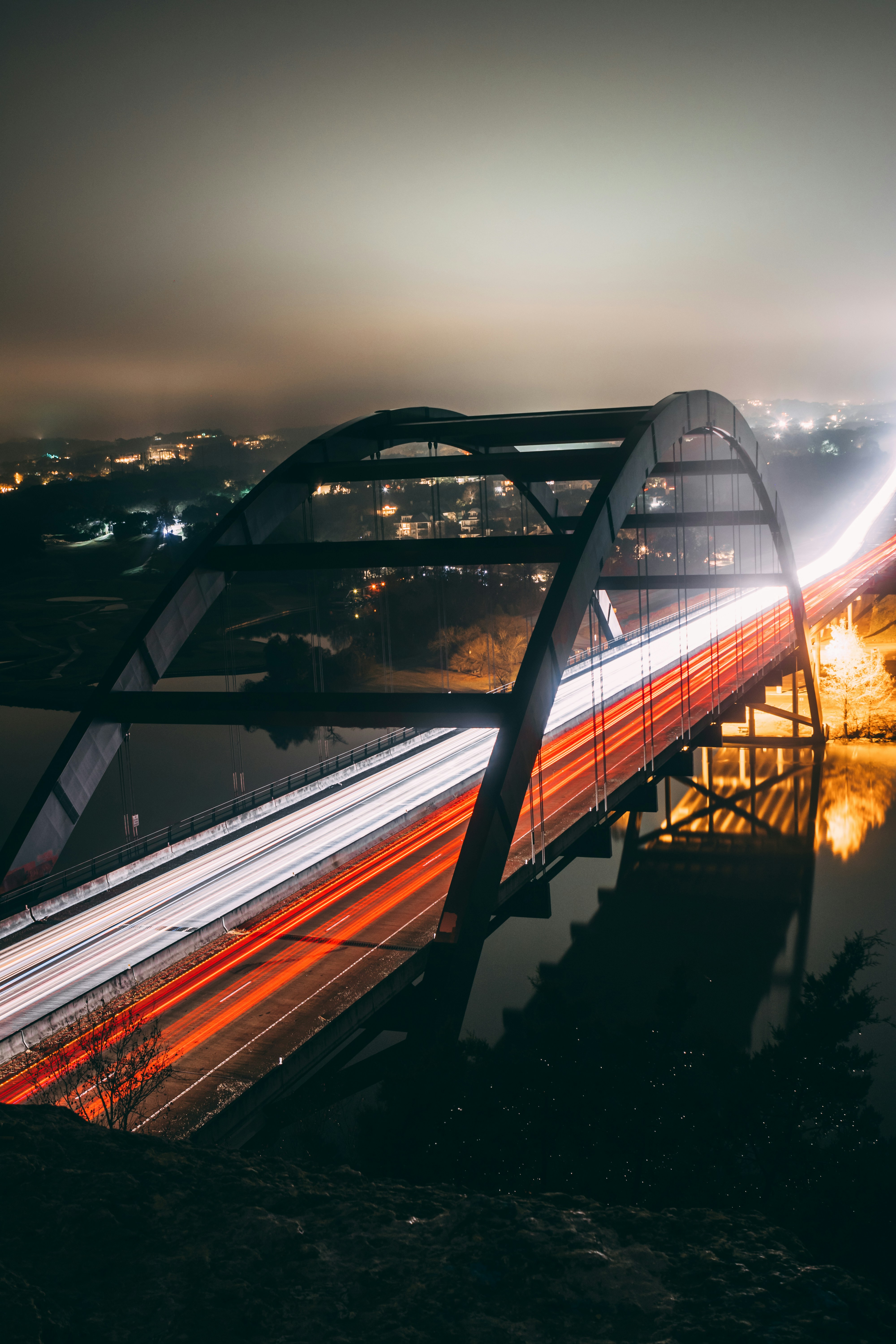 Austin 360 Bridge at night with traffic light trails over Lake Austin