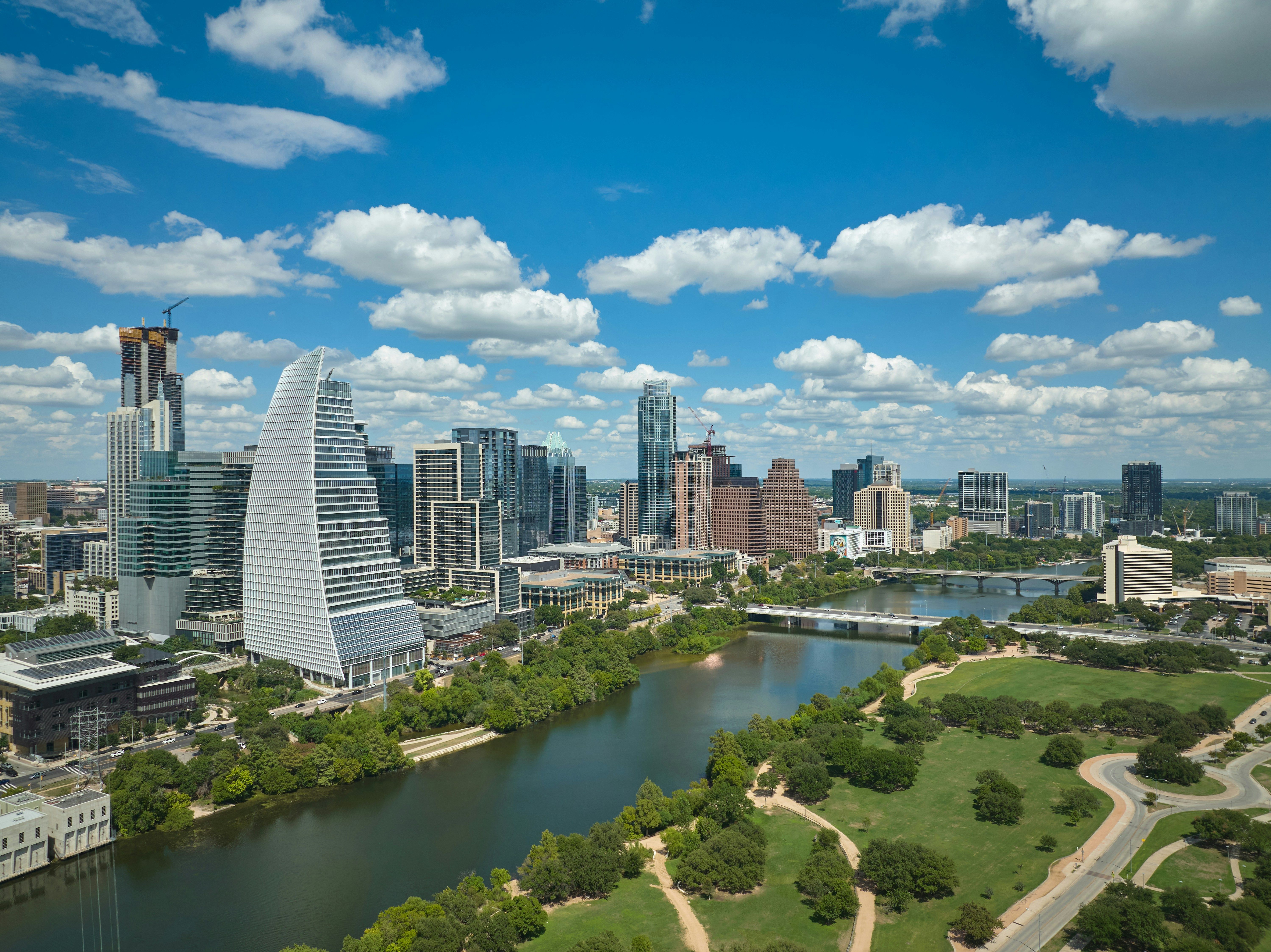 Aerial view of downtown Austin skyline with Lady Bird Lake and green parks